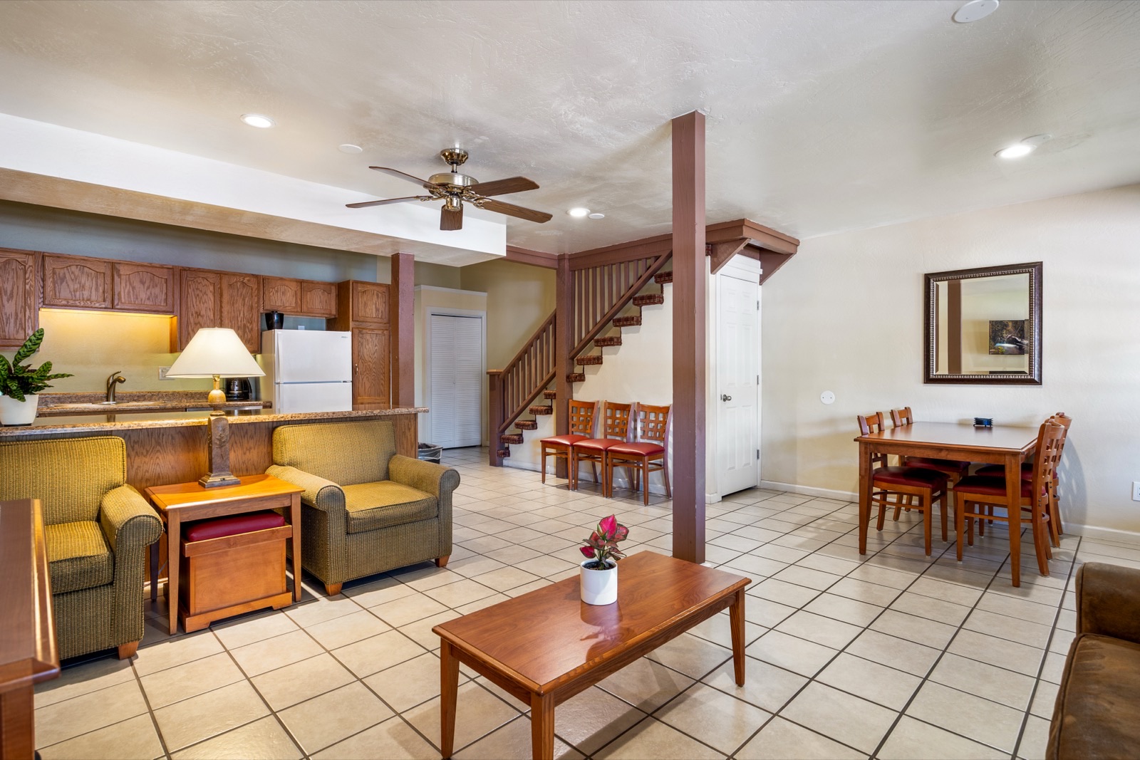 Two bedroom deluxe with two-story layout, staircase, kitchen, and living area
